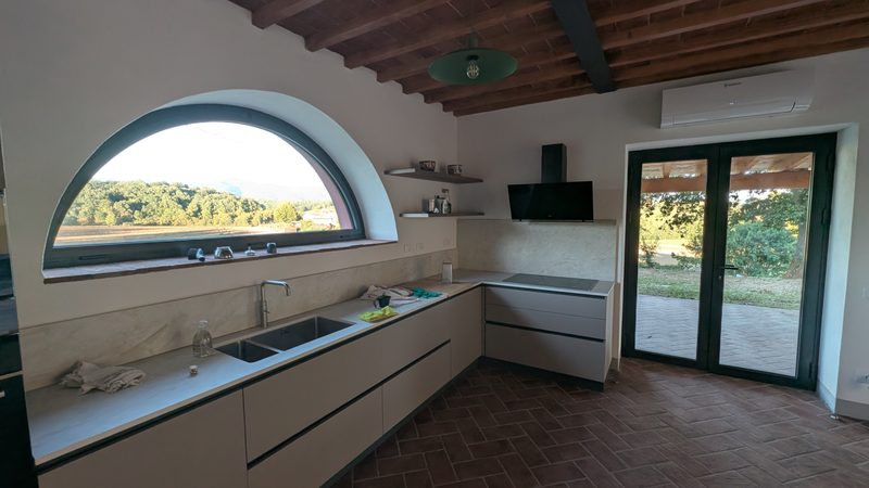 La cucina del Fienile e la finestra ad arco.